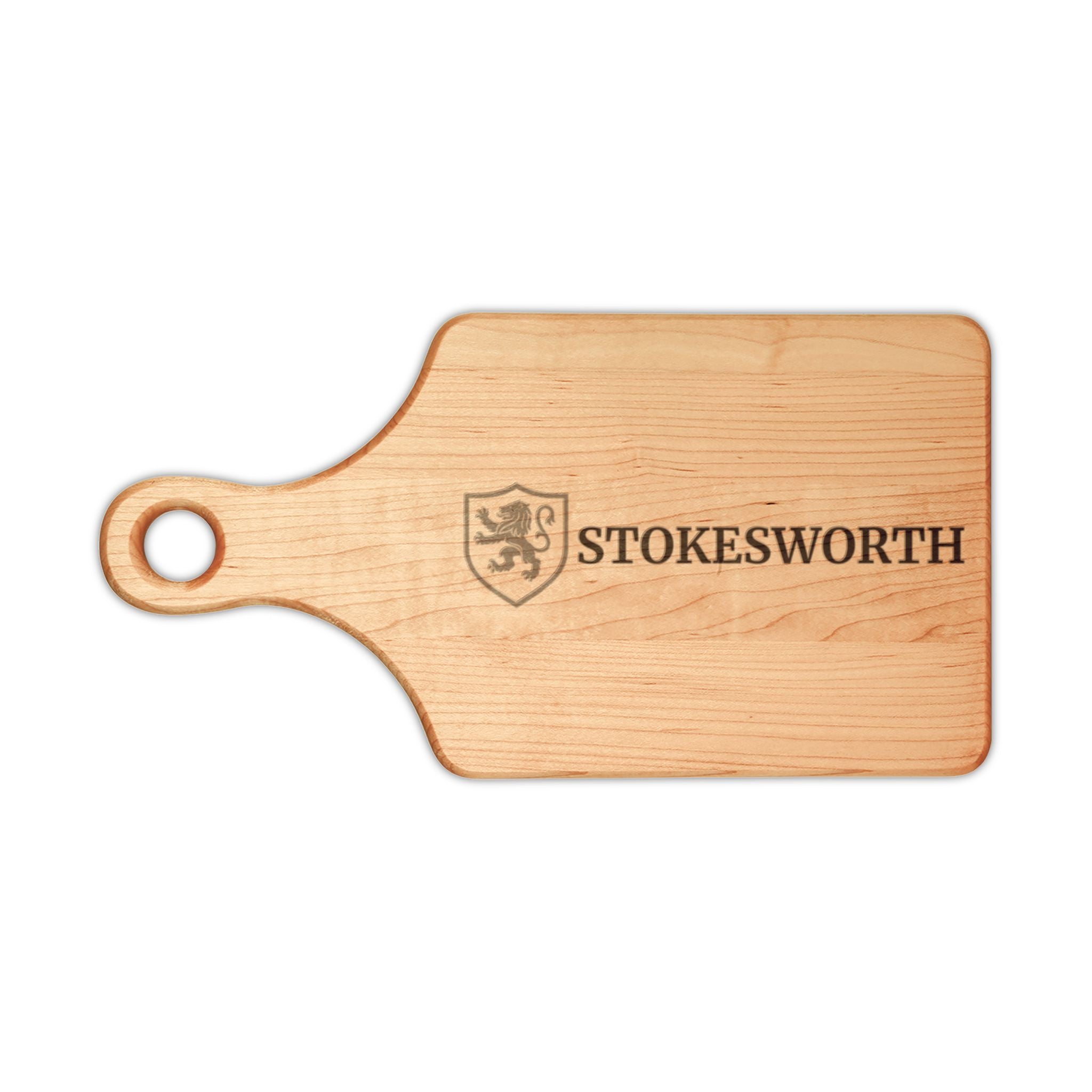 A rectangular wooden cutting board with a rounded handle and a hole for hanging, featuring a dark engraved shield crest and the word 'STOKESWORTH' on a plain white background.